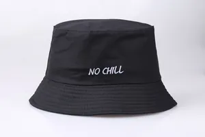 Detailed close-up of NO CHILL white embroidery on a black canvas bucket hat fabric