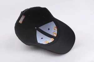 Detail of CCCP gold embroidery on black cotton baseball cap showing internal structure
