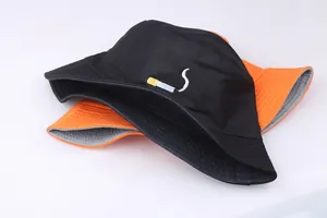 Street style cotton bucket hats in black and orange with cigarette embroidery detail