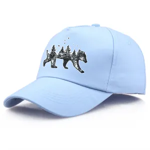 Light blue cotton baseball cap featuring a forest bear silhouette and pine trees print