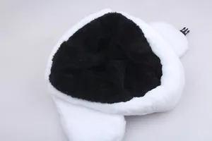 Detail of white faux fur winter hat showing inner black lining and plastic buckle