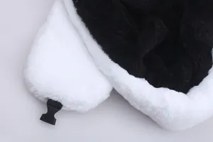 Detail of soft black and white faux fur winter hat featuring a sturdy plastic buckle closure