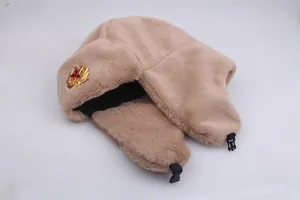 Detail of light brown faux fur trapper hat with Soviet red star metal badge and buckle