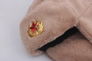 Close-up of khaki faux fur aviator hat featuring a Soviet CCCP metal badge detail