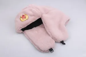 Close-up of pink faux fur ushanka hat with Soviet red star badge and buckle strap