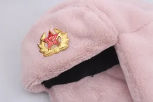 Detailed view of pink ushanka fur and Soviet style metal badge with star and sickle