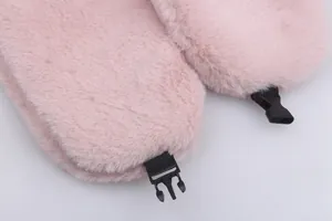 Detail of pink plush ear flap featuring a durable black plastic buckle and nylon strap