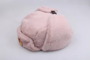 Detail of pink Ushanka hat featuring faux fur texture and a Soviet emblem badge with buckle