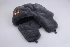 Detail of grey Ushanka hat featuring Soviet emblem and soft faux fur lining for winter