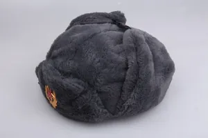 Detail of grey faux fur Ushanka hat featuring a Soviet CCCP red star metal badge