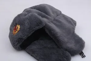 Detail of grey Ushanka winter hat featuring faux fur texture and Soviet red star badge