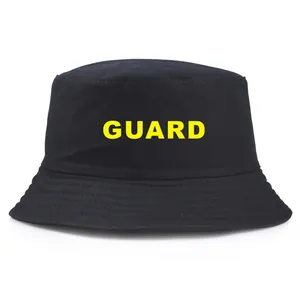 Classic black cotton bucket hat featuring a bold yellow GUARD print on the front panel