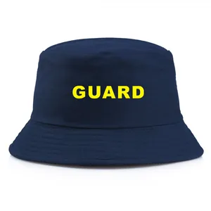 Dark blue cotton canvas bucket hat featuring a yellow GUARD print on a white background