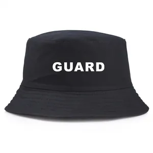 Black cotton bucket hat with white GUARD lettering print shown on a plain white background