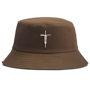 Brown cotton bucket hat featuring white Jesus cross embroidery on a white background