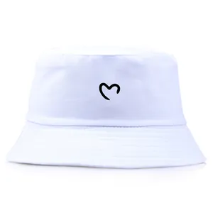 Minimalist white cotton bucket hat with black heart embroidery for outdoor sun protection