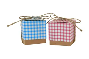Detail of mini kraft candy boxes with blue and pink plaid lids and silver key charms