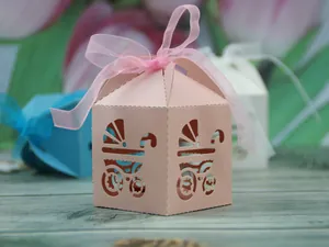 Detail of pink laser-cut baby stroller favor box with a delicate matching ribbon bow
