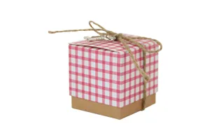 Detail of square kraft paper candy box with red white checkered lid and key charm