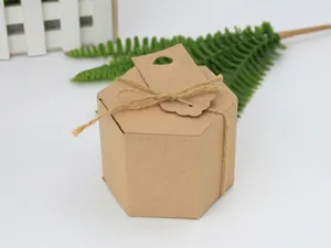 Close-up of hexagonal kraft paper gift box with rustic twine bow and hanging tag detail