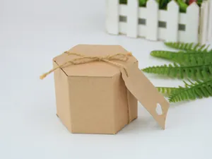 Detail of hexagonal kraft paper gift box with rustic twine bow and heart-cutout tag