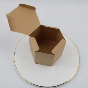 Hexagonal brown kraft paper gift box with lid displayed on a decorative white porcelain plate