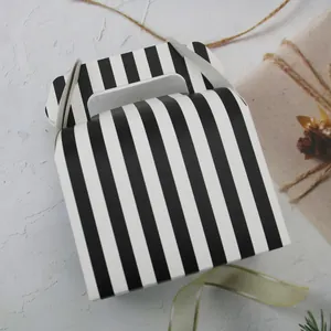 Large paper cake box with black and white vertical stripes and integrated handle