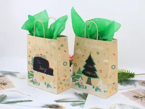 Close-up of brown Kraft paper Christmas gift bags with snowflake patterns and green tissue