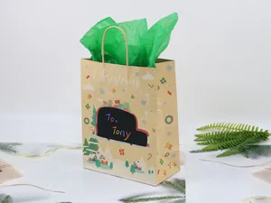 Detail view of a DIY Christmas kraft gift bag with a truck and rainbow To: Tony lettering