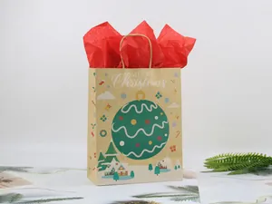 Detail of kraft paper Christmas gift bag with green bauble print and Merry Christmas text
