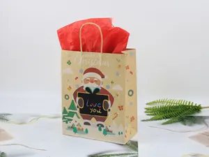 Close-up of a Christmas kraft gift bag with Santa Claus print and red tissue paper