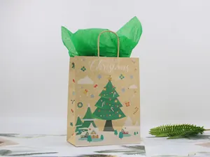 Detail of Christmas kraft paper gift bag with green tree pattern and Merry Christmas text