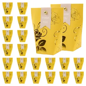 Elegant yellow gift bags with gold foil rose patterns and Thank You labels for weddings