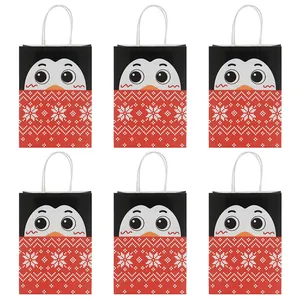 Christmas kraft paper gift bags with cute penguin patterns and white rope handles