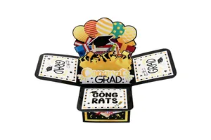 Detailed view of 3D graduation greeting card with black and gold balloons and cap