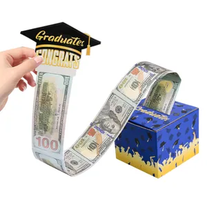 Action shot of pulling a money roll from a graduation surprise gift box with prop bills