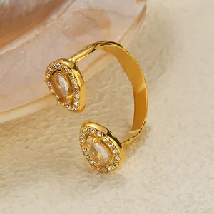 Detail of gold-plated open ring with pear-shaped stones and clear cubic zirconia halo