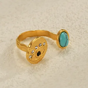 Macro detail of gold hammered ring featuring turquoise stone and evil eye design