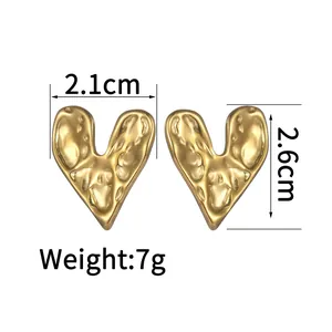 Detail view of 18K gold plated heart studs with hammered texture and 2.6cm height