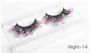 Macro detail of handmade dramatic false eyelashes with pink glitter and purple sequins
