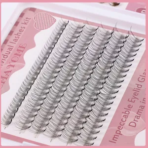 Macro detail of natural black individual lash clusters arranged in an eyelash extension kit