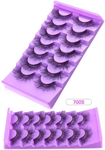 Macro detail of 7 pairs of 3D faux mink eyelashes with natural cross density in a tray