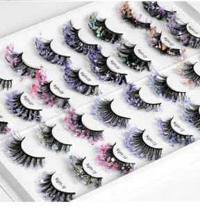 Detailed set of 16 pairs of faux eyelashes with vibrant colorful glitter and sequins