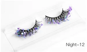 Macro shot of thick creative false eyelashes with purple blue glitter sequins on a tray