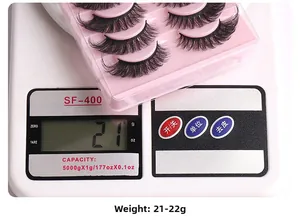 Detailed view of ten pairs of cat eye false eyelashes on a scale weighing 21-22 grams