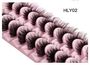 Close-up of ten pairs of voluminous fox-eye false eyelashes on a pink display tray
