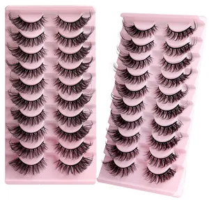 Macro detail of ten pairs of dense wispy cat eye false eyelashes on pink tray