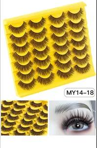 Vue détaillée de 14 paires de faux cils épais et recourbés sur un plateau jaune vif