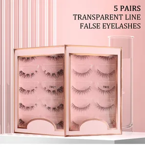 Detail of 5 pairs of natural fake eyelashes with transparent lines on pink glitter board