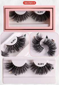 Close-up of fluffy black false eyelashes with Christmas tree and snowman ornaments